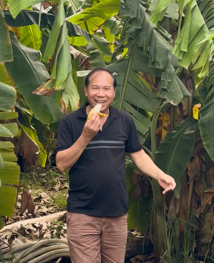 Dad eating a banana on the farm