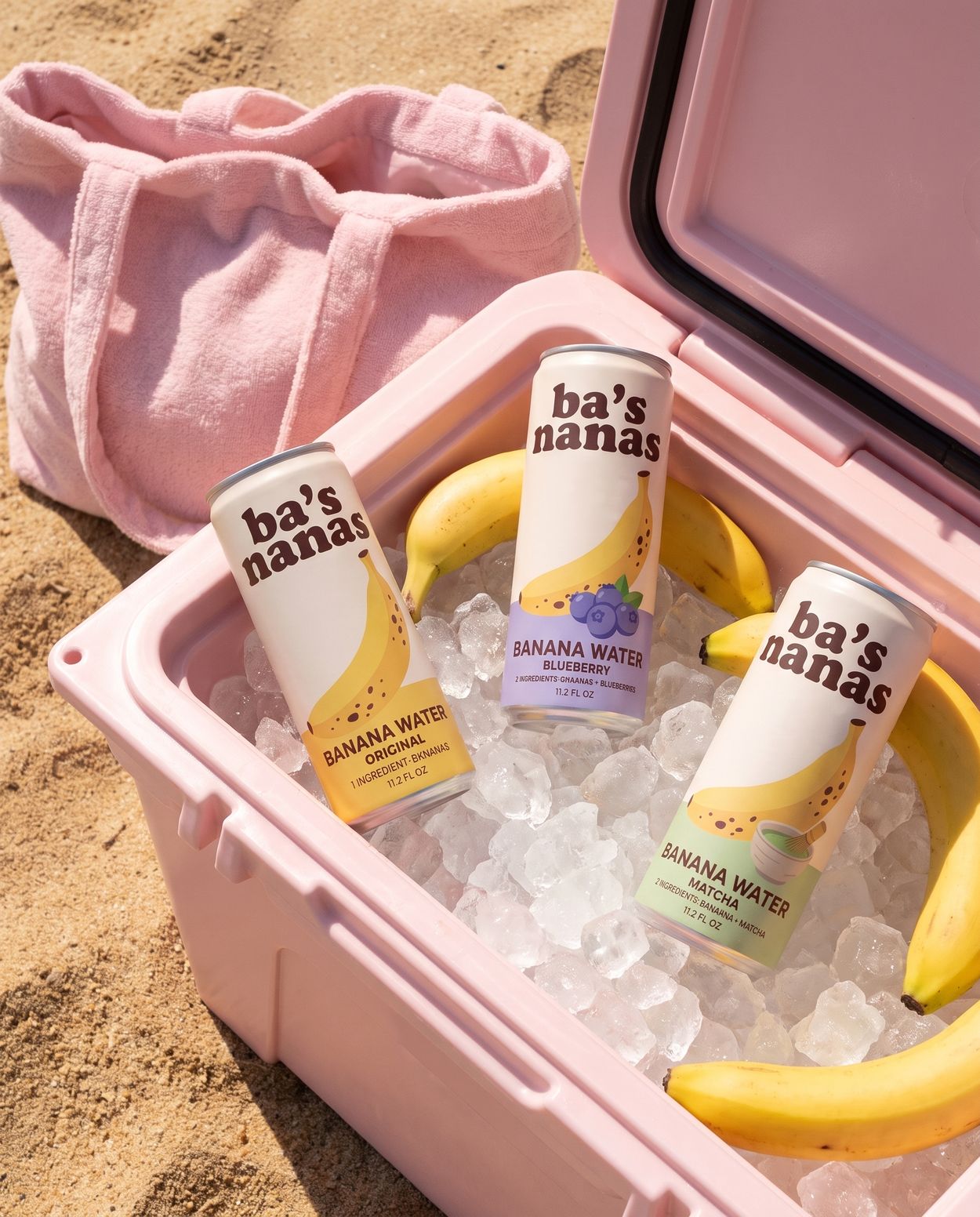 Original, Blueberry and Matcha cans on ice in a pink cooler with bananas